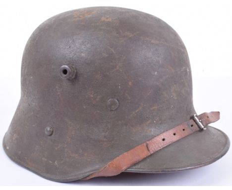 Austrian M-17 Steel Helmet, complete with its original combat paint finish to the exterior and interior of the shell. Helmet 