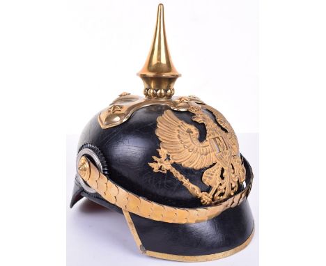 Imperial German Prussian Dragoon Officers Pickelhaube, black leather shell with brass trim to the square dip peak, brass Prus