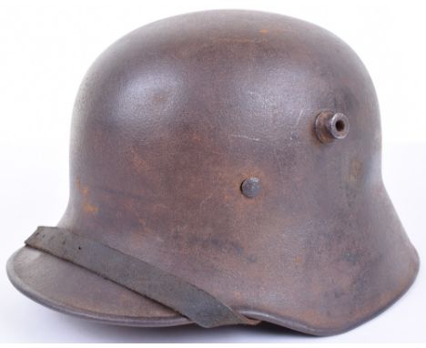 Austrian M-17 Steel Helmet, with dark brown paint finish and surface rusting. Helmet has been refurbished with a WW2 style Ge