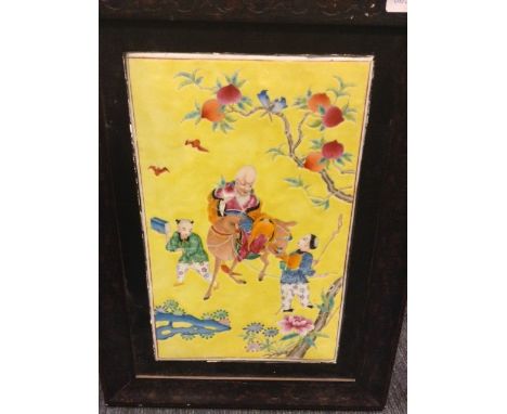 PAIR OF EARLY 20TH CENTURY CHINESE FAMILLE JAUNE CERAMIC PANELS depicting Shao Lao, framed in wooden frames, 52cm x 39cm over