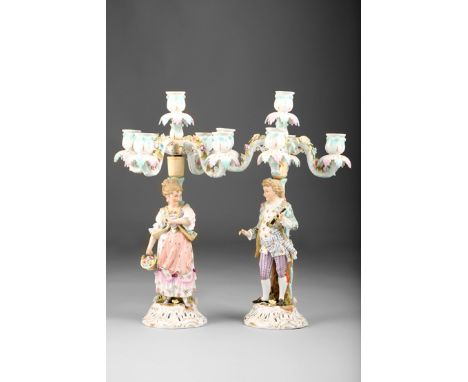 Pair of continental porcelain figure candelabra four light, courting couple raised on Rococo style bases, 40cm high