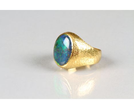 Gents 18 carat yellow gold signet ring with a mounted oval shaped opal measuring 16mm x 12mm, total weight 11.4 grams. Size S