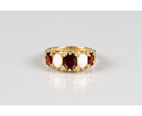 Ladies 9 carat gold garnet and opal ring. Size M