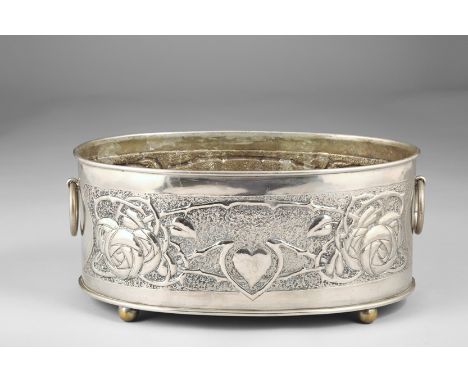 Scottish School Arts and Crafts, white metal planter oval form, loop handles, raised on bun feet. Decorated with embossed sty