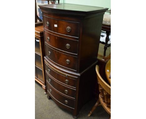 A bow fronted six-height chest of drawers 