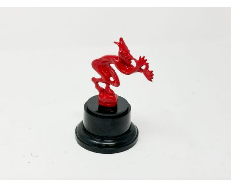 Red enamelled accessory mascot fitted to Edwardian and Vintage motor cars at the back of the car to give an amusing but offen