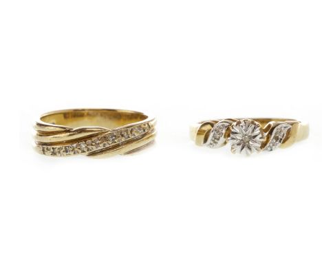 DIAMOND DRESS RING, set with a single diamond chip in a star setting, the shoulders of waved form each set with a single diam