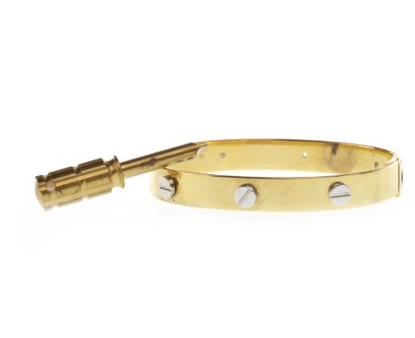 CHILD'S SCREW MOTIF BANGLE, of oval form, in yellow gold with applied white gold screw head motifs to the exterior, marked 37