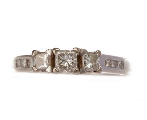 DIAMOND THREE STONE RING, set with graduated princess cut diamonds totalling approximately 0.22 carats overall, on channel se