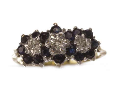BLUE AND WHITE GEM SET CLUSTER RING, formed by three floral clusters, each with a central diamond chip surrounded by blue gem