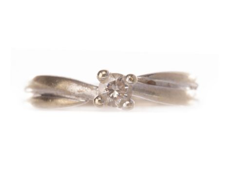 DIAMOND SOLITAIRE RING, with a four claw set round brilliant cut diamond of approximately 0.10 carats, marked 750, size K, 2.