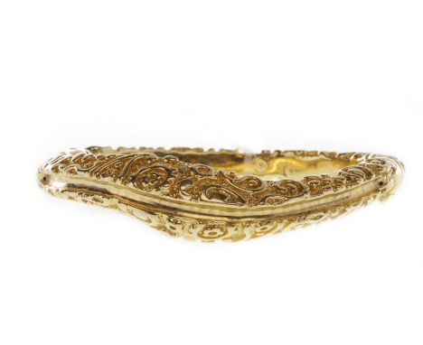 GOLD BANGLE, with textured scrolling foliate decoration, marked 750, 16.13g