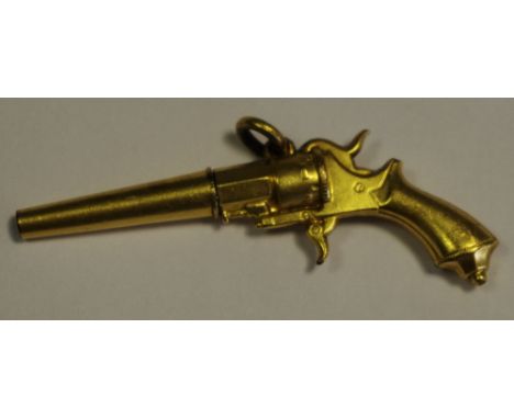 An early 20th century yellow metal novelty pocket watch winder, in the form of  a revolver