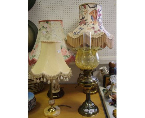 An early 20th century brass oil lamp, amber glass shade, a substantial gilt metal lamp base, with shade, a brass and alabaste