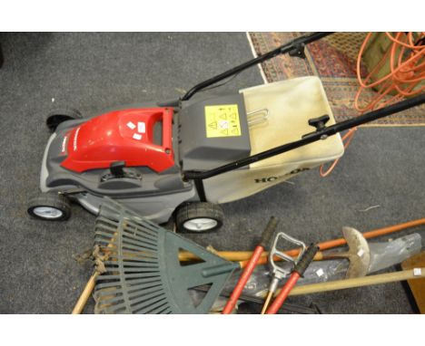 A Honda HRE370 electric lawnmower; a Vax carpet shampooer; a bench grinder; an electric tile cutter; a mitre saw; drain rod; 