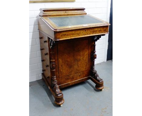 19th century walnut Davenport, with sloping top and inset skivver over four drawers with carved supports and ceramic castors,