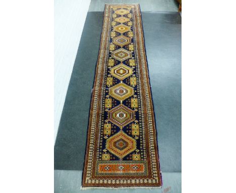 Eastern runner, the blue field with nine medallions and geometric borders, 350 x 80cm 