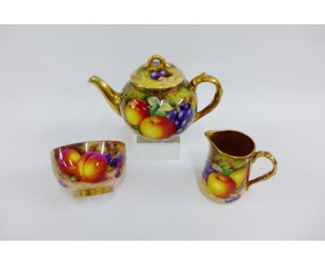 Royal Worcester fruit study teapot by Freeman, painted in the round with apples, pear and grapes to a mossy ground, with blac