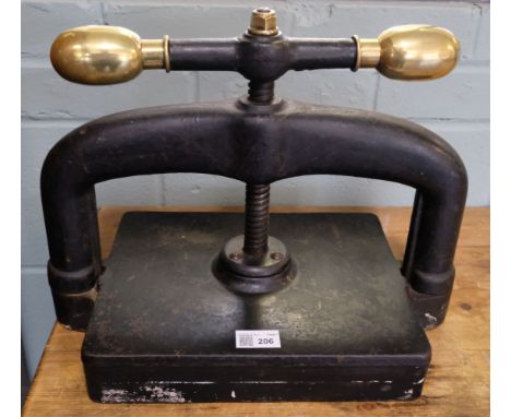 * Bookpress. A cast iron bookpress, finished in black, with brass handle ends, platen approximately 30 x 25 cm (11.75 x 10 in