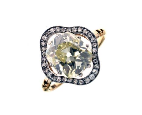 Early 20th century diamond 18ct yellow gold and platinum set halo ring, the champagne oval cushion cut diamond measuring appr