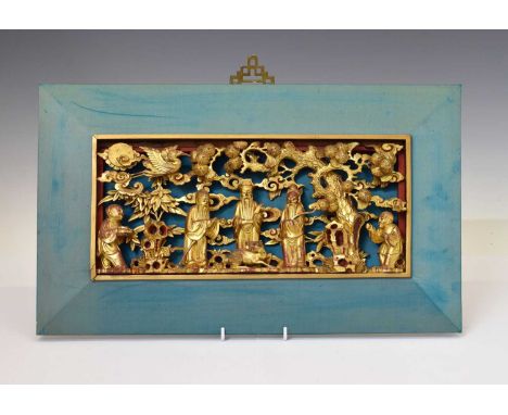 Chinese carved giltwood panel, late Qing dynasty, depicting five figures and a deer in a lanscape beneath a pine tree, a cran