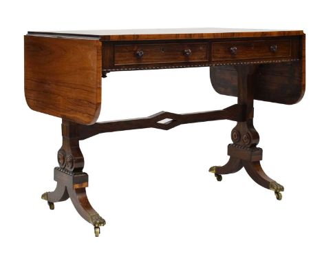 George IV rosewood sofa table, circa 1825, the rounded rectangular drop-leaf top above a pair of frieze drawers, with false f