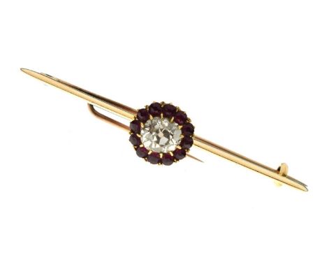 Early 20th century diamond and ruby cluster yellow metal bar brooch, the old cushion cut diamond measuring approx. 5.87 x 6.6