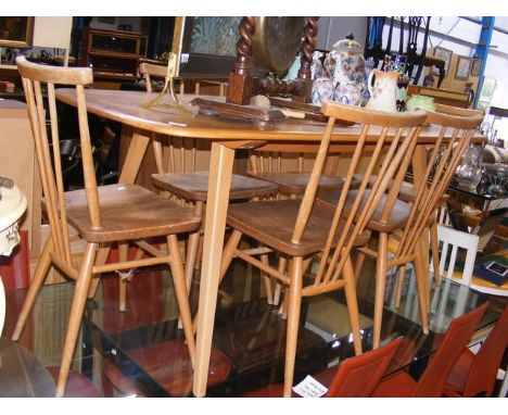 An Ercol 'Golden Dawn' dining table with six chairs 