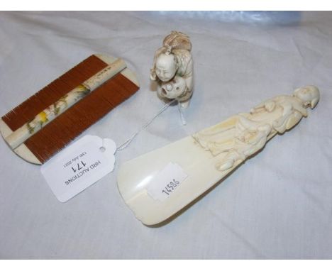 A Japanese comb, Chinese ivory shoe horn, together with a Japanese carved Netsuke - height 5cms CONDITION REPORT.