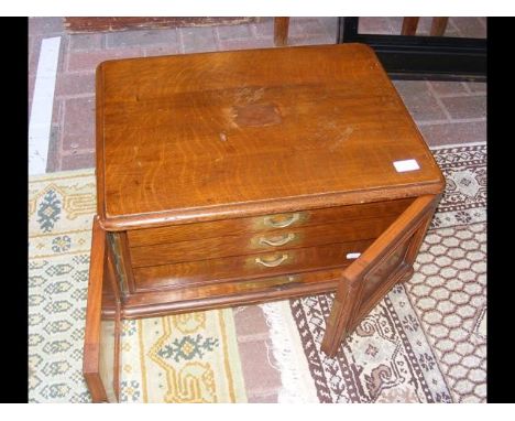 An oak three drawer chest with panelled doorsCONDITION REPORTThis item has recessed side carrying handles.
