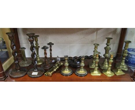 Shelf of brass & treen candlesticks