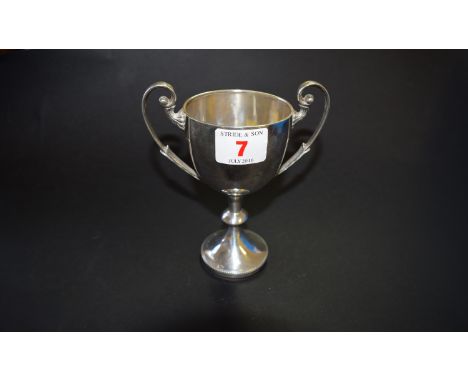 An Edwardian silver twin handled trophy cup, by W.B Ltd, Birmingham 1904, 12.5cm, 129g; together with a B.H.S enamel and meta