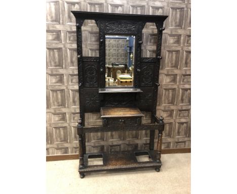 VICTORIAN EBONISED OAK HALLSTAND, the moulded cornice over a bevelled mirror panel, two shelves and a series of coat hooks, w