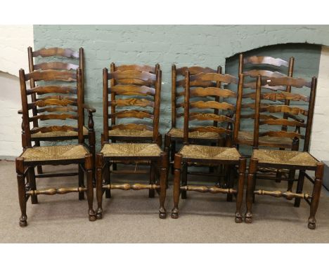 A set of eight carved ash and elm ladder back chairs, six dining and two carver.