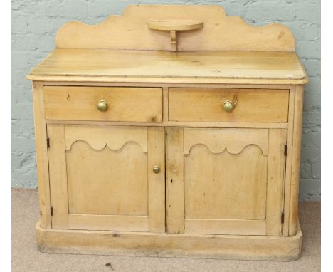 A Victorian pine sideboard with shaped backrest and corbel shelf.