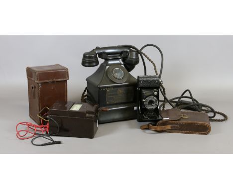 A vintage Bakelite telephone; automatic telephone and Electric Co. Ltd, a leather cased Bakelite record insulation tester and