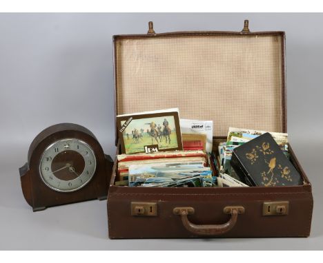 A small leather suitcase containing maps, postcards and mantel clock etc.
