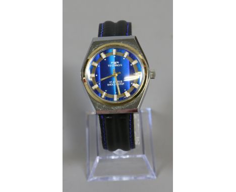 A vintage gents Technos manual wristwatch with centre seconds baton markers on black leather strap.