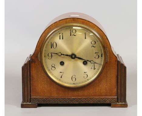 A walnut cased mantel clock with brass dial and silent strike mechanism chiming on a coiled gong complete with pendulum and k
