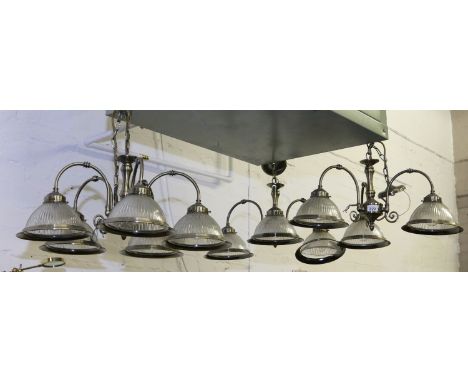 Three brass effect ceiling light fittings one five branch with ribbed glass shades and two matching three branch fittings.