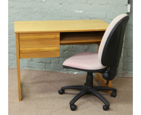 An office swivel chair and light oak desk.