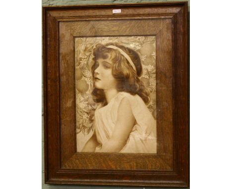 An oak framed print of a girl.