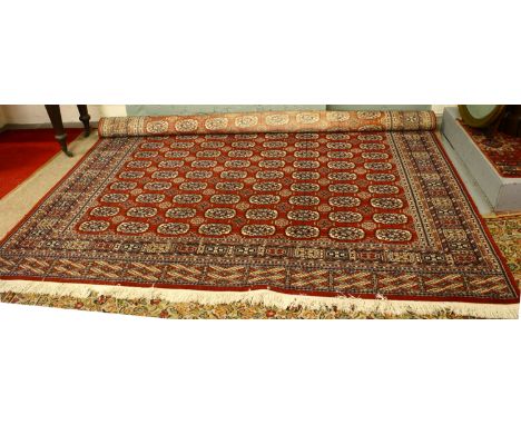 A large red ground wool carpet 360 x 275cm.
