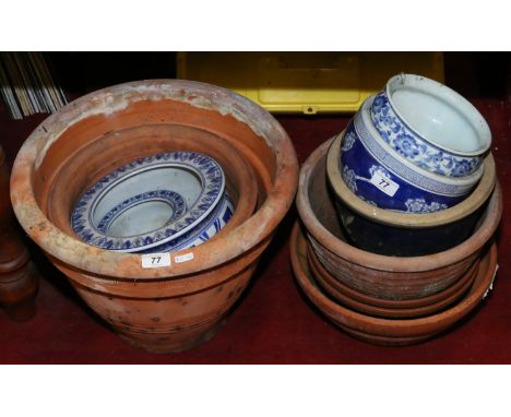 A collection of terracotta planters along with five Chinese ceramic pots.