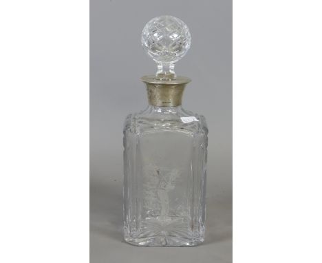 A 1998 silver collared crystal decanter with engraved image of a golfer.