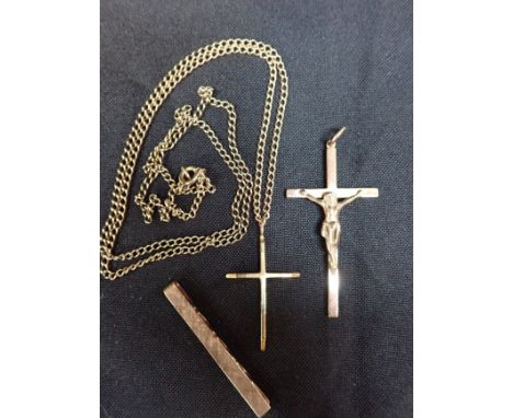 A GOLD CRUCIFIX 6 cms long, with another gold crucifix and chain, and a gold tie clip