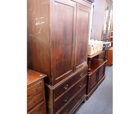 A CHIPPENDALE REVIVAL MAHOGANY LINEN PRESS with carved door and drawer mouldings, fitted with sliding trays 103cm wide (damag