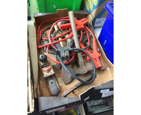 A box of tools, including car jump leads 