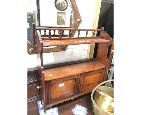A mahogany rack with lower cupboard and turned finial rail, h64cm, w58cm. 
