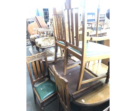 A mahogany cabriole leg extending dining table on ceramic castors with a set of 6 chairs having carved and scrolled tops. 